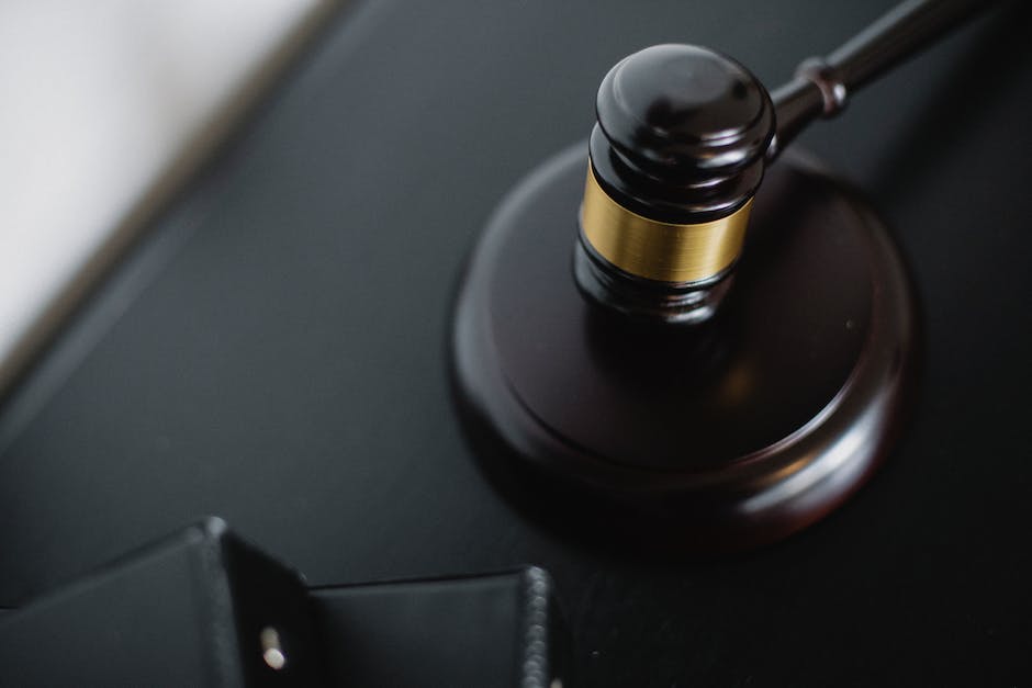 Image of a person dressed in professional attire, sitting at a desk with legal documents and a gavel, symbolizing trial preparation